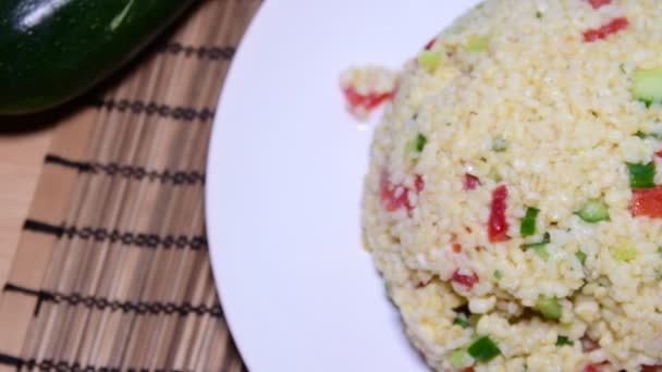 Bulgur also burghul with vegetables. Flat view of bulgur. Tomatoes on the table. Low DOF. — Stock Video