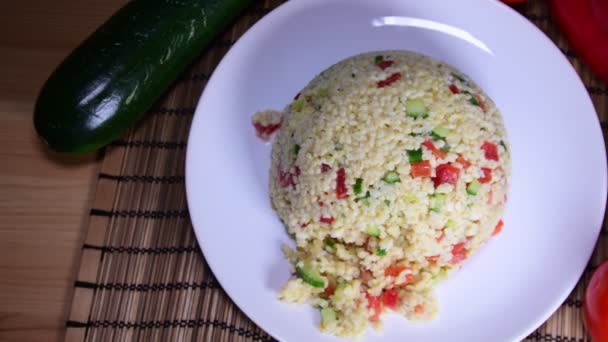 Bulgur also burghul with vegetables. Flat view of bulgur. Tomatoes on the table. — Stock Video