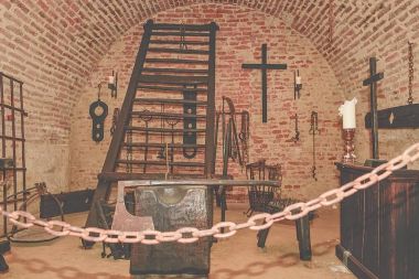 Inquisition torture chamber. Old medieval torture chamber with many pain tools clipart