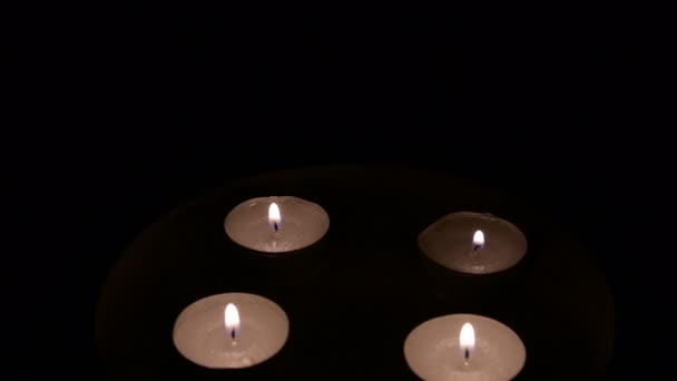 Group of burning tea light candles, rotating. Closeup. — Stock Video