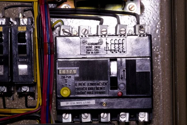 Old 3 phase circuit breaker in electric distribution case. Closeup