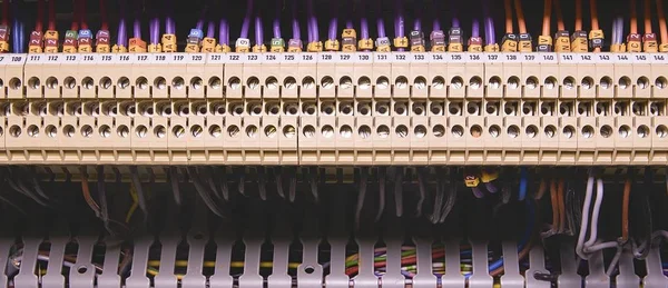 Terminal blocks for electrical connection and earthing terminals for grounding in the control cubicle. Wires with caption fields