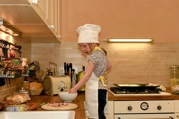 Cute small girl cooks in the rural kitchen.  Little girl prepares pizza. — Stock Photo, Image