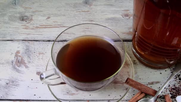 Black tea, manual squeezer with lemons. A jug of black tea and cubes of sugar. — Stock Video