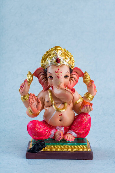 Hindu God Ganesha. Ganesha Idol on blue background.