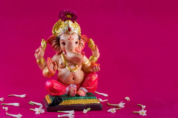 Hindu God Ganesha. Ganesha Idol on pink background.