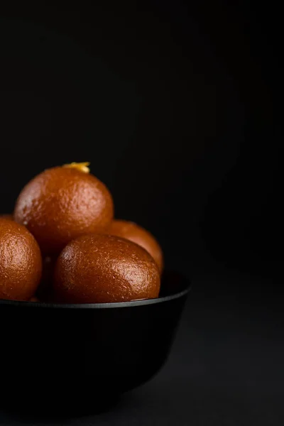 Gulab Jamun in bowl on black background. Indian Dessert or Sweet Dish. — Stock Photo, Image