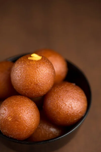 Indian Dessert or Sweet Dish: Gulab Jamun in bowl on wood background . — Stok Foto