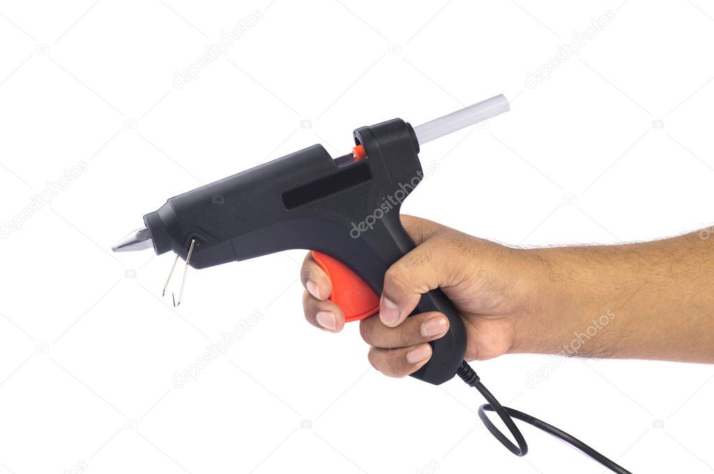 Hand holding Electric hot glue gun isolated on white background