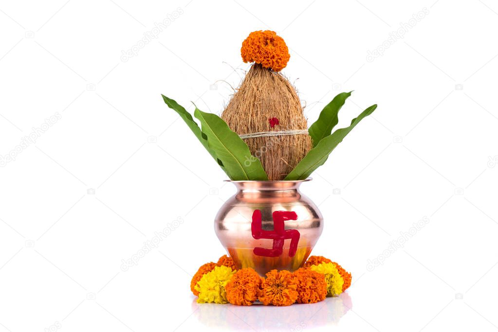 Copper Kalash with coconut and mango leaf with floral decoration on a white background. Essential in Hindu Puja.