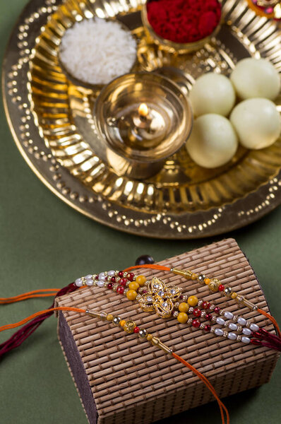 Indian Festival: Raksha Bandhan or Rakhi background with an elegant Rakhi and diya Stock Photo