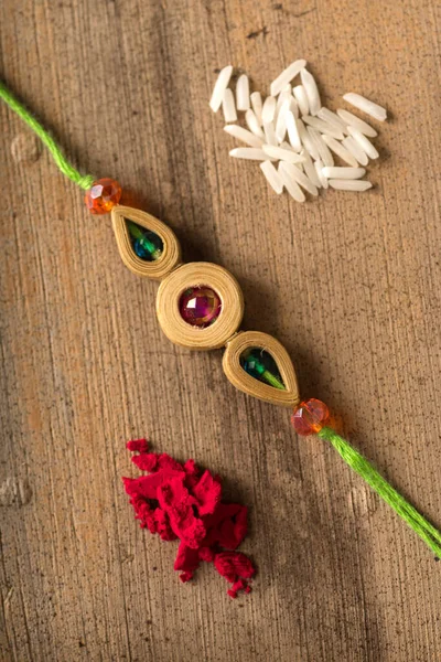 Festival indiano: Raksha Bandhan fundo com um elegante Rakhi, grãos de arroz e Kumkum. Uma pulseira tradicional indiana que é um símbolo de amor entre irmãos e irmãs. — Fotografia de Stock