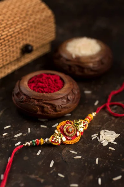 Raksha Bandhan zarif bir Rakhi, pirinç taneleri, Kumkum ve hediye kutusuna sahip. Geleneksel Hint bilekliği Kardeşler ve Kız Kardeşler arasındaki aşkın sembolüdür.. — Stok fotoğraf
