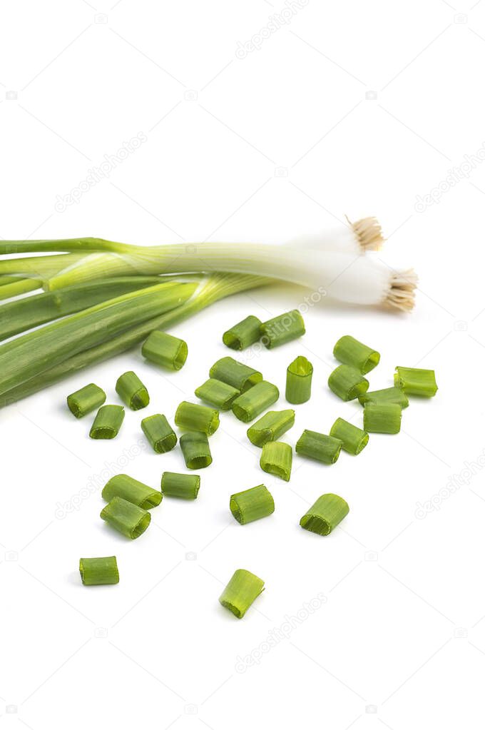 Fresh ripe green spring onions (shallots or scallions) with fresh chopped green onions on white background