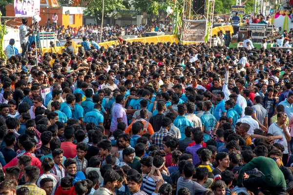 AMRAVATI, MAHARASHTRA, INDIA - 8 SEPTEMBER 2018: Crowd of young People enjoying and dancing in the "Govinda" at Dahi Handi festival to celebrate God Krishna's Birth. Royalty Free Stock Images