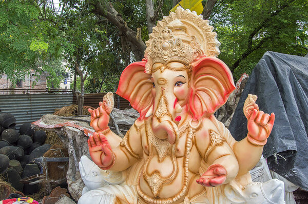 Statue of Hindu God Ganesha. close up of Ganesha Idol at an artist's workshop during Ganesha Festival.