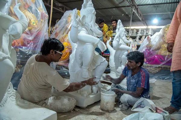 AMRAVATI, MAHARASHTRA - 8 SETTEMBRE 2018: Artista che fa una statua e dà un tocco finale a un idolo del dio indù Lord Ganesha in un laboratorio d'artista per il festival Ganesha . — Foto Stock