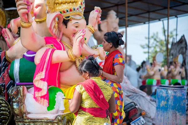 AMRAVATI, MAHARASHTRA - 8 DE SEPTIEMBRE DE 2018: Artista haciendo una estatua y dando toques finales a un ídolo del dios hindú Lord Ganesha en un taller de artista para el festival Ganesha . — Foto de Stock