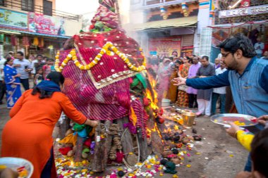 Amravati, Maharashtra, Hindistan, Mart - 1, 2018: Tahta kütüklere ya da hindistan cevizine taparak Holika Dahan 'ı kutlayan kimliği belirsiz insanlar. Holi renk festivali ya da paylaşım festivali olarak da bilinir.