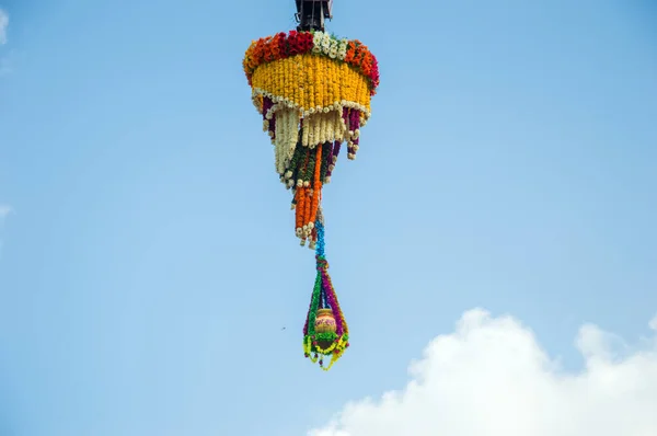 Dahi Handi background on Gokul Ashtami festival with hanging pot filling with curd with flower decoration. — Stock Photo, Image