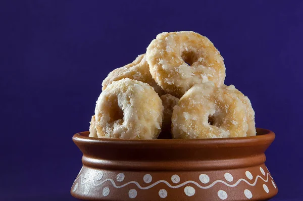 Indian Traditional Sweet Food Balushahi on a violet background