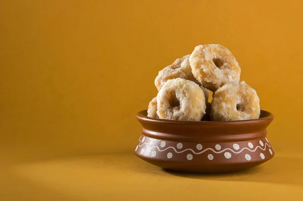 Indian Traditional Sweet Food Balushahi on a yellow background