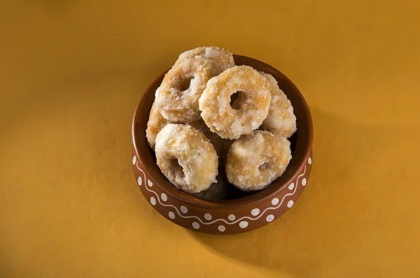 Indian Traditional Sweet Food Balushahi on a yellow background