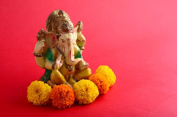 Hindu God Ganesha. Ganesha Idol on red Background.