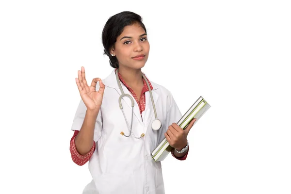 Young woman doctor holding book with stethoscope — Stock Photo, Image