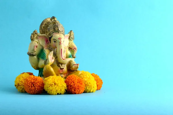 Hindu God Ganesha. Ganesha Idol on Blue Background