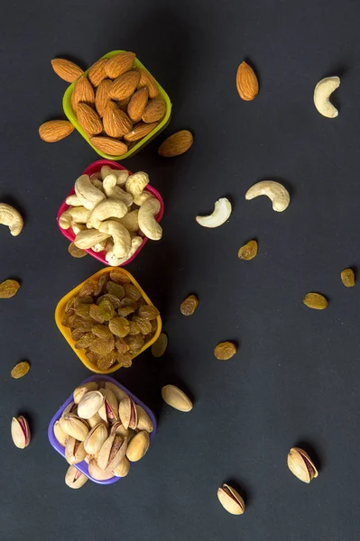 Healthy Mix Dry Fruits and Nuts on dark background. Almonds, Pistachio, Cashews, Raisins — Stock Photo, Image