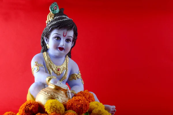 Hinduguden Krishna på rød bakgrunn – stockfoto