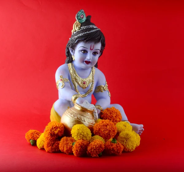 พระเจ้าฮินดู Krishna บนพื้นหลังสีแดง — ภาพถ่ายสต็อก