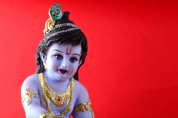 Hinduguden Krishna på rød bakgrunn – stockfoto