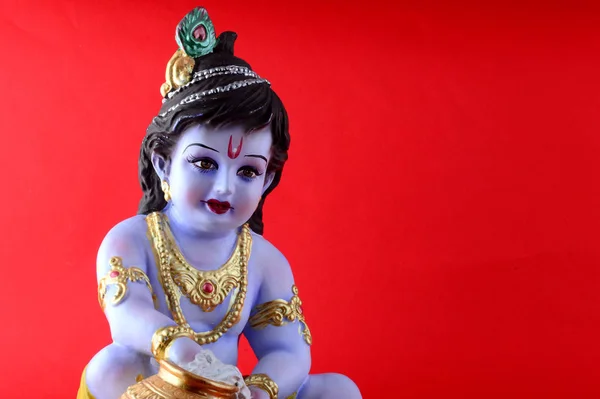 Hindu Gud Krishna på rød baggrund - Stock-foto