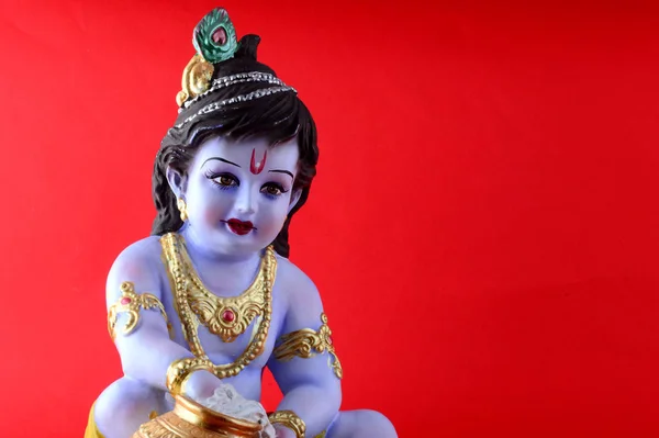 Hindu God Krishna on red background — Stock Photo, Image