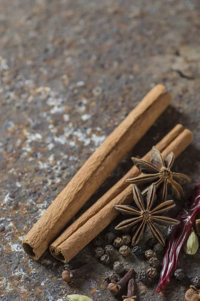 Spices and herbs. Food and cuisine ingredients. Cinnamon sticks, anise stars, black peppercorns, Chili, Cardamom and Cloves on textured background — Stock Photo, Image