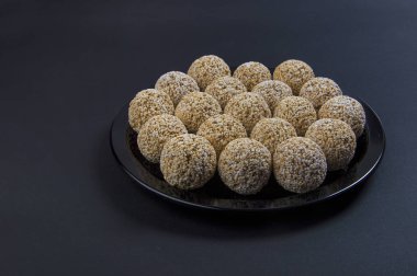 Amaranth ladoo ya da Rajgira laddu ya da siyah arka planda siyah tabakta Cholai ke laddo.