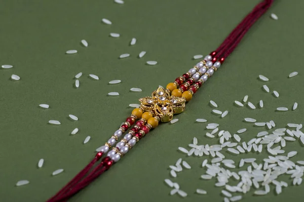 Raksha Bandhan bakgrund med en elegant Rakhi. Ett traditionellt indiskt armband. — Stockfoto