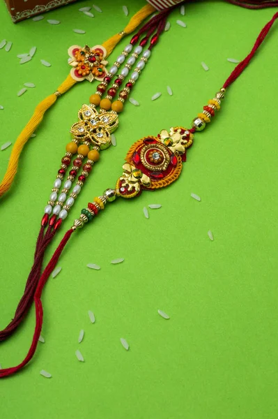 Raksha Bandhan background with an elegant Rakhi. A traditional Indian wrist band which is a symbol of love between Brothers and Sisters. — Stock Photo, Image