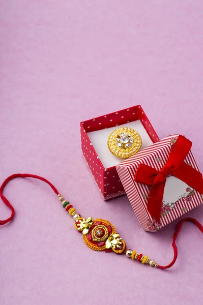 Raakhi y un regalo para la hermana dado por el hermano con motivo de Raksha Bandhan. Festival indio Raksha Bandhan fondo con un elegante Rakhi . — Foto de Stock