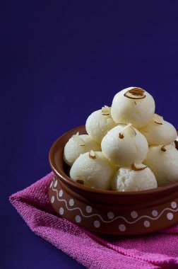 Hint Tatlısı veya Tatlısı - Rasgulla, Meşhur Bengali tatlısı Mor arka planda mavi peçete