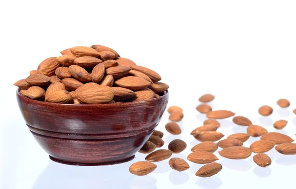 Almonds in a wooden bowl isolated on a white background — Stock Photo, Image