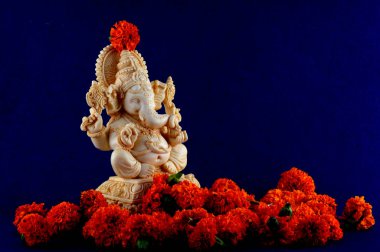 Hindu God Ganesha. Ganesha Idol on blue background clipart