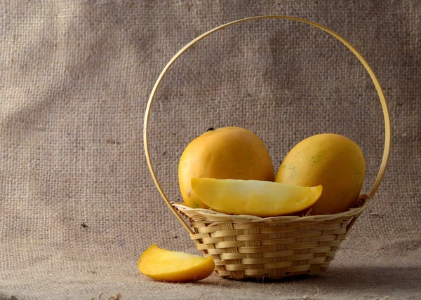 Mango fruit in basket on sack cloth background — Stock Photo, Image