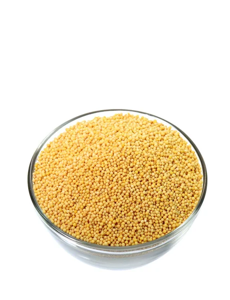 Yellow mustard seeds in glass bowl isolated on white background — Stock Photo, Image