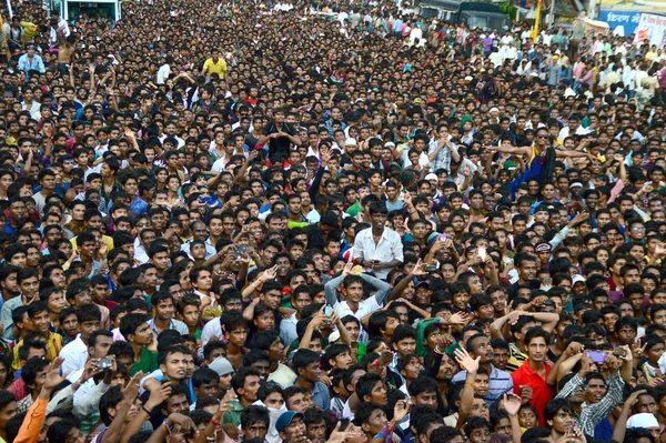 AMRAVATI, MAHARASHTRA, INDIA - AUGUST 24 : Crowd of young People enjoying "Govinda" at Dahi Handi festival to celebrate God Krishna's Birth in Amravati, Maharashtra, India. 24 August 2014 Stock Picture