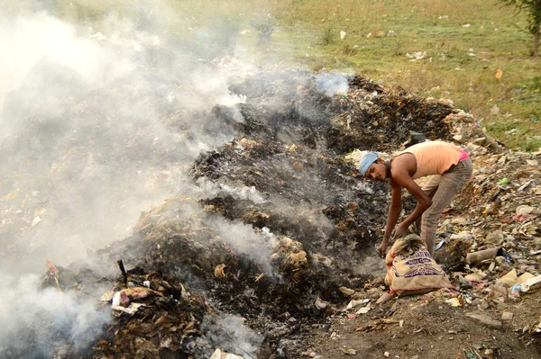 AMRAVATI, MAHARASHTRA, INDIA - APRILE 09, 2014: Raccoglitori di stracci non identificati cercano materiale riciclabile nella spazzatura. Inquinamento del suolo e dell'aria in India il 09 aprile 2014, Amravati, India . — Foto Stock