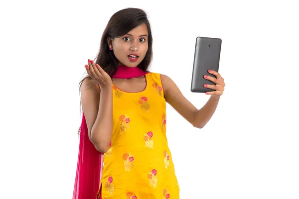 白い背景に隔離されたタブレット 携帯電話やスマートフォンを使用して若いインドの女の子 — ストック写真