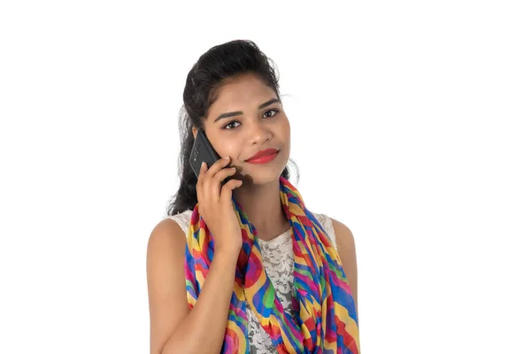 使用白色背景隔离的手机或智能手机的年轻印度女孩 — 图库照片
